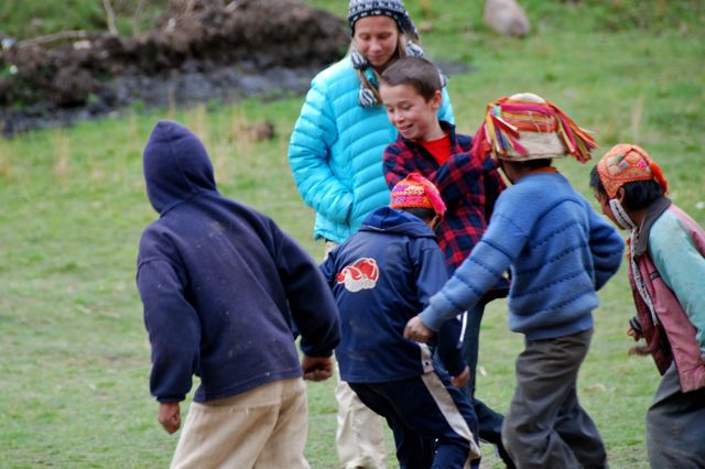 Dana White: Family Travel Planner Extraordinaire 4 Dana White children playing soccer with Quechua kids