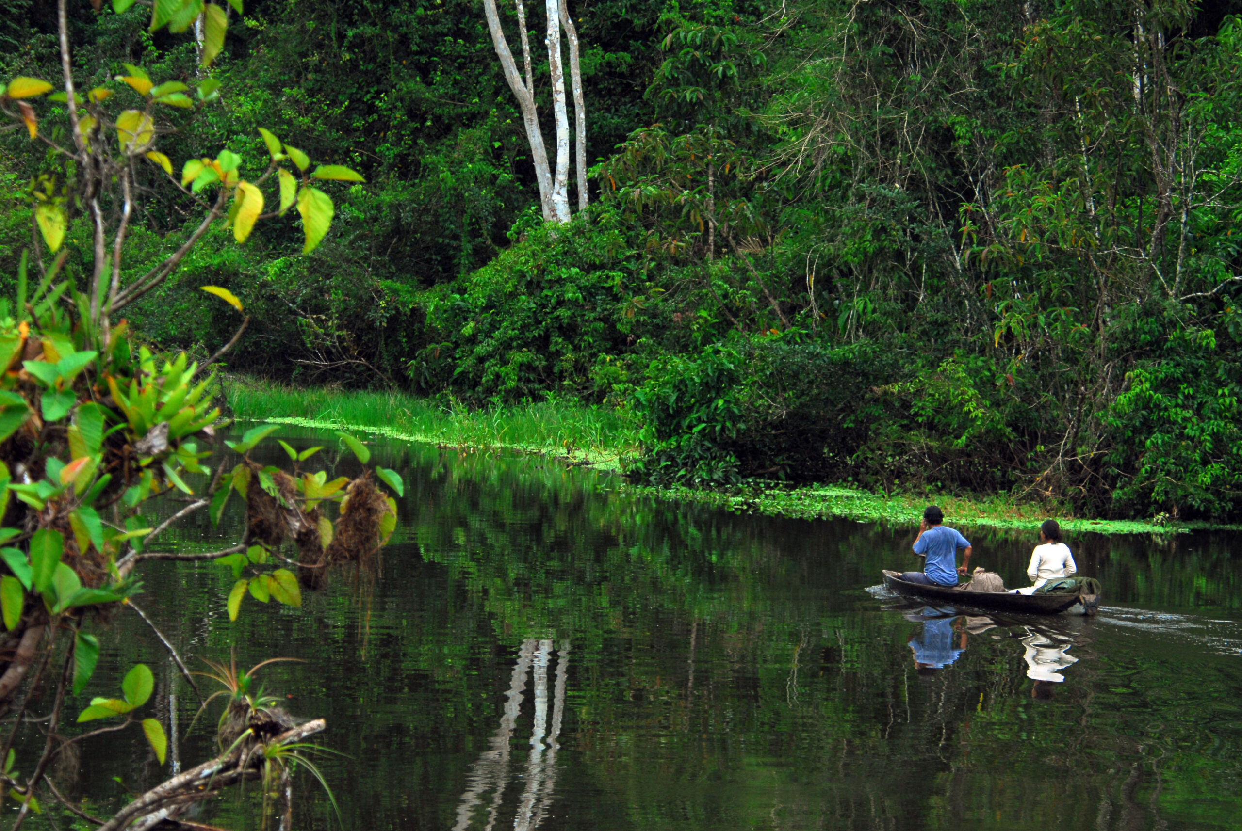 Native people on canoe. High Resolution scaled