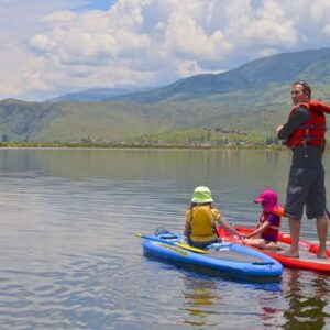 Travelling To Peru With Kids: The 10 Best Activities 11 dad daughter paddle boarding